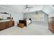 Spacious bedroom with a ceiling fan, three windows, carpeted floor, and antique furniture at 1007 Surry Dale Ct, Apex, NC 27502