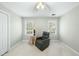 Bedroom with neutral walls, carpet, and features a comfortable gray armchair at 1007 Surry Dale Ct, Apex, NC 27502