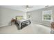 Bedroom with neutral walls, carpet, ceiling fan, and closet features a metal bed frame at 1007 Surry Dale Ct, Apex, NC 27502