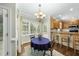 Charming breakfast nook with a chandelier, bright windows, and cozy table, perfect for morning meals at 1007 Surry Dale Ct, Apex, NC 27502