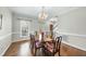 Bright dining room with traditional wood furniture, chandelier, and hardwood floors at 1007 Surry Dale Ct, Apex, NC 27502