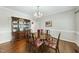 Dining room with a china cabinet, hardwood floors, and a traditional chandelier at 1007 Surry Dale Ct, Apex, NC 27502