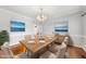 Formal dining room with table set for dinner and views of lake landscape art at 1007 Surry Dale Ct, Apex, NC 27502