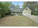 Traditional two-story home with yellow siding, blue shutters, front porch, and two car garage at 1007 Surry Dale Ct, Apex, NC 27502
