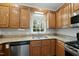 Efficient kitchen setup with granite countertops, stainless steel dishwasher, and ample cabinet space for storage at 1007 Surry Dale Ct, Apex, NC 27502