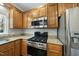 Modern kitchen showcasing stainless steel appliances, granite countertops, and classic wooden cabinetry at 1007 Surry Dale Ct, Apex, NC 27502