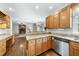 Spacious kitchen area with a breakfast bar, wooden cabinets, and a view to the living room at 1007 Surry Dale Ct, Apex, NC 27502