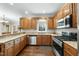 Functional kitchen with granite countertops, wooden cabinetry, and modern appliances, ideal for cooking enthusiasts at 1007 Surry Dale Ct, Apex, NC 27502