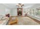 Comfortable living room with a brick fireplace, plush carpeting, and natural light, ideal for relaxation at 1007 Surry Dale Ct, Apex, NC 27502
