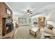 Open-concept living area featuring a fireplace, ceiling fan, and hardwood floors at 1007 Surry Dale Ct, Apex, NC 27502