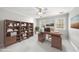 Staged office featuring a modern wooden desk and shelving unit at 1007 Surry Dale Ct, Apex, NC 27502