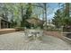 Charming backyard patio with stone pavers, umbrella-covered table with seating, and a view of the landscaped yard at 1007 Surry Dale Ct, Apex, NC 27502