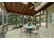 Inviting screened porch with skylights, ceiling fan, and outdoor dining set overlooking a lush backyard at 1007 Surry Dale Ct, Apex, NC 27502