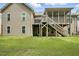 Inviting backyard featuring a deck, screened porch, and steps leading down to the yard at 1056 Lukestone Dr, Fuquay Varina, NC 27526