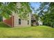 Spacious backyard with a view of the home's screened porch and well-maintained lawn at 1056 Lukestone Dr, Fuquay Varina, NC 27526