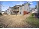Home exterior with a large backyard, featuring a deck and spacious area for outdoor activities and entertaining at 1056 Lukestone Dr, Fuquay Varina, NC 27526