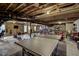 Unfinished basement with concrete flooring and exposed beams; ping pong table and exercise equipment included at 1056 Lukestone Dr, Fuquay Varina, NC 27526