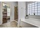 Bright bathroom features a soaking tub, glass shower, walk in closet and lots of natural light at 1056 Lukestone Dr, Fuquay Varina, NC 27526