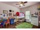Playful pink bedroom featuring a bunk bed with a play tent, a blue desk, and hardwood floors at 1056 Lukestone Dr, Fuquay Varina, NC 27526