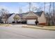 A side angle view of a single Gathering home with brick and siding at 1056 Lukestone Dr, Fuquay Varina, NC 27526