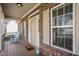 Inviting front porch with rocking chair and brick facade at 1056 Lukestone Dr, Fuquay Varina, NC 27526