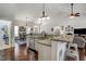 Bright, open kitchen featuring stainless steel appliances, granite countertops, and a large island with barstool seating at 1056 Lukestone Dr, Fuquay Varina, NC 27526