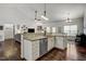 Bright kitchen with granite counters, stainless appliances, undermount sink and views of the living spaces at 1056 Lukestone Dr, Fuquay Varina, NC 27526