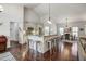 Spacious, open-concept kitchen with granite counters, modern appliances, and a large island with seating at 1056 Lukestone Dr, Fuquay Varina, NC 27526