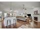 A spacious open-concept living area with kitchen island, fireplace and comfortable seating area at 1056 Lukestone Dr, Fuquay Varina, NC 27526