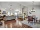 Open-concept living space with hardwood floors connecting the living room, dining area, and kitchen at 1056 Lukestone Dr, Fuquay Varina, NC 27526