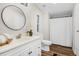 Well-lit bathroom with a modern vanity, round mirror, and a shower/tub combination for convenience at 110 Hickory Dr, Spring Hope, NC 27882