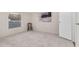 Spacious bedroom with neutral walls, carpet, large window, and cozy chair creating a relaxing retreat at 110 Hickory Dr, Spring Hope, NC 27882