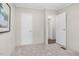 Bedroom with neutral carpet, open doorway, and a white door, providing a cozy and accessible space at 110 Hickory Dr, Spring Hope, NC 27882