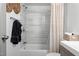 Modern bathroom with tiled shower/tub, wicker details, and new fixtures at 1110 Schaub Dr # B, Raleigh, NC 27606
