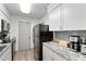 Modern kitchen featuring white cabinets, granite countertops, stainless steel appliances, and gray backsplash at 1110 Schaub Dr # B, Raleigh, NC 27606