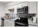 Bright kitchen featuring stainless appliances, gray backsplash, granite countertops, and ample storage space at 1110 Schaub Dr # B, Raleigh, NC 27606