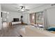 Bright living room with a sliding glass door to the exterior, fan, hardwood floors, and modern decor at 1110 Schaub Dr # B, Raleigh, NC 27606