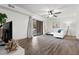 Spacious living room with sliding glass doors, white sofa, hardwood floors, and contemporary lighting at 1110 Schaub Dr # B, Raleigh, NC 27606