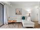 Cozy living room with a large sectional sofa, wood-look floors, modern art, and natural light at 1110 Schaub Dr # B, Raleigh, NC 27606