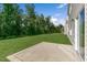 A spacious backyard features a concrete patio and lush green grass with mature trees at 116 Pisgah St, Sanford, NC 27330