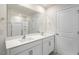 Bright bathroom featuring a double sink vanity with white cabinets and a shower with glass doors at 116 Pisgah St, Sanford, NC 27330