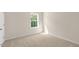 Bedroom with neutral carpeting and a window letting in natural light at 116 Pisgah St, Sanford, NC 27330