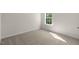 Carpeted bedroom with window providing natural light and outdoor views at 116 Pisgah St, Sanford, NC 27330