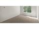 Neutral carpeted bedroom featuring a bright window for ample natural light at 116 Pisgah St, Sanford, NC 27330