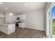 Modern kitchen area with stainless steel appliances, granite countertops, and access to the backyard through sliding glass doors at 116 Pisgah St, Sanford, NC 27330