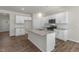 Well-lit kitchen featuring stainless steel appliances, granite countertops, a kitchen island, and a convenient pantry at 116 Pisgah St, Sanford, NC 27330