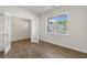 Bright living space features wood-look flooring, a large window with backyard view, and a modern French door at 116 Pisgah St, Sanford, NC 27330