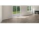 Open living space featuring wood-look floors, a cozy fireplace, and sliding glass doors to the backyard at 116 Pisgah St, Sanford, NC 27330