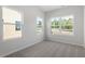 Bedroom with multiple windows and neutral carpeting and paint at 120 Central Townes Way # 292, Raleigh, NC 27603