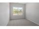 Bedroom with a large window offering natural light and lush green view at 120 Central Townes Way # 292, Raleigh, NC 27603